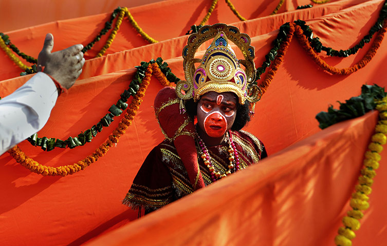 24 hours: New Delhi, India: A supporter dressed as Hindu monkey god Hanuman