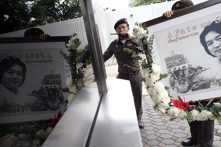 24 hours: Bangkok, Thailand: Thai policemen carry a picture of Hiro Muramoto