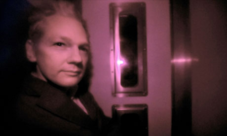 Julian Assange, pictured through the heavily tinted windows of a police vehicle