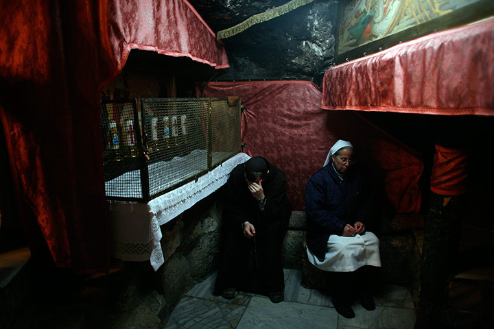 24 hours in pictures: A monk and a nun pray inside Church of the Nativity, in the West Bank
