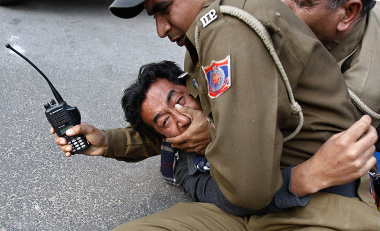 24 hours in pictures: Police detain a Tibetan exile during a protest in New Delhi