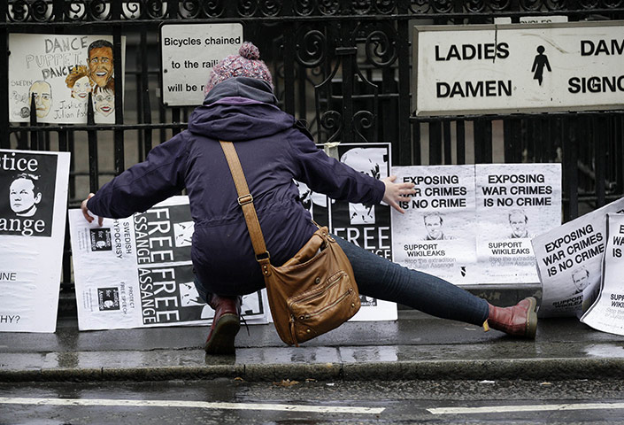 Julian Assange Trial: A woman places banners in support of WikiLeaks founder Julian Assange