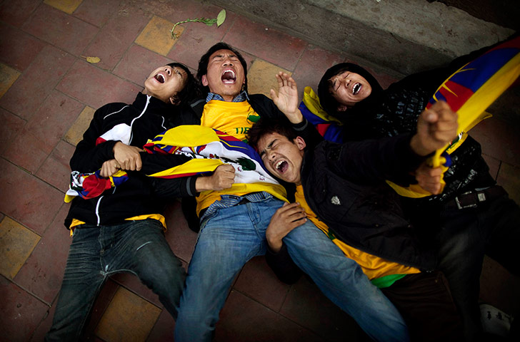 24 hours in pictures: Tibetan students lock arms before being detained by Indian police
