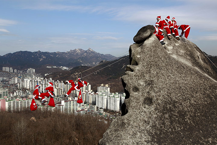 24 hours in pictures: Rock-climbers in Santa Claus costumes
