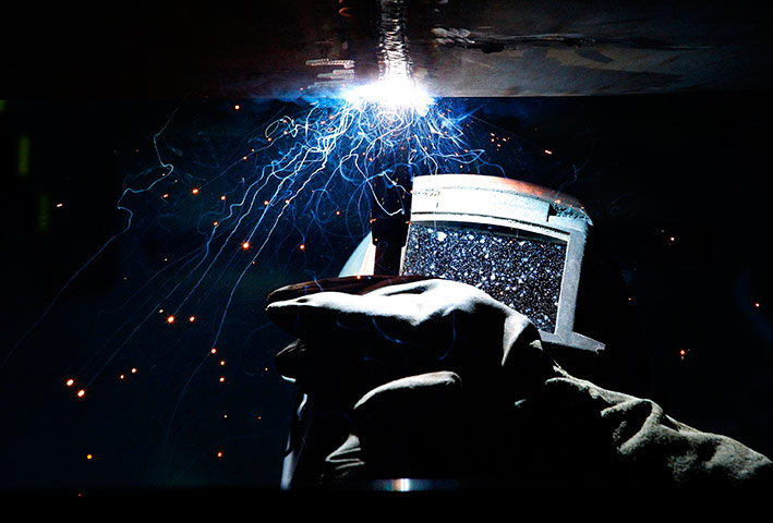 24 hours in pictures: A welder works on a Queen Elizabeth Class aircraft carrier