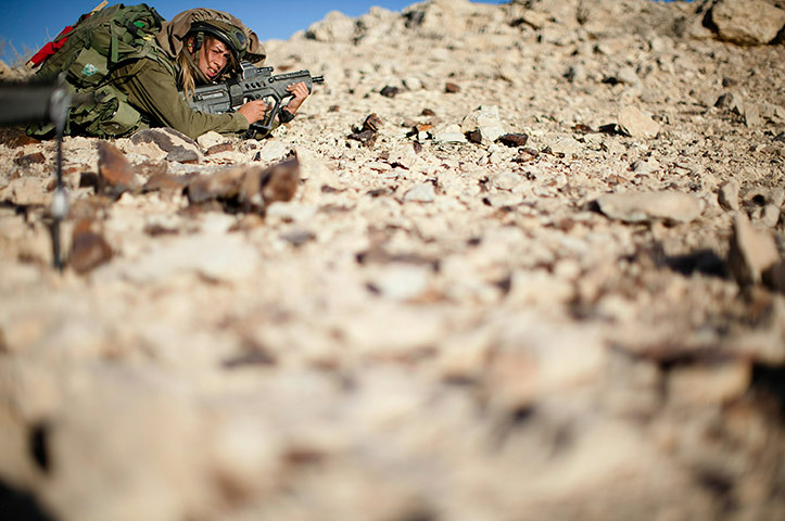 24 hours in pictures: A female soldier from the 'Karakal' Battalion in action during training