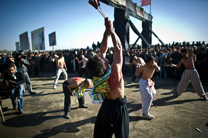 24 hours in pictures: Afghan Shiite Muslim men beat themselves with chains and blades