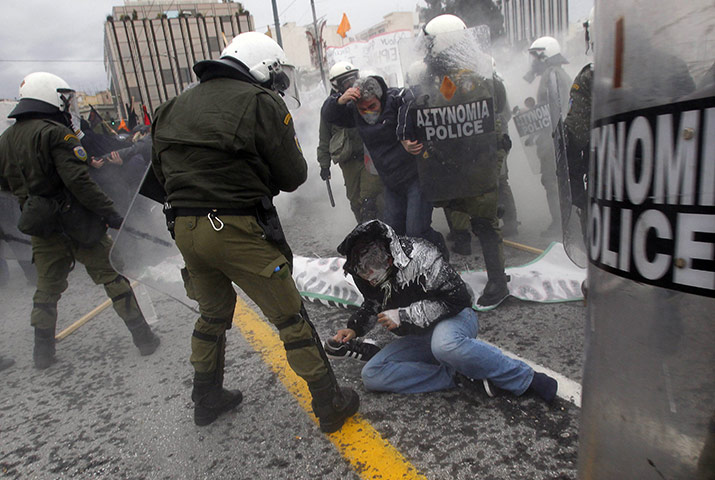 Business Week in Pictures: A protester falls on the ground during clashes in central Athens