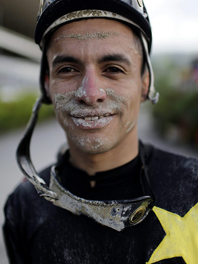 Fromtheagencies Cubillos: Jockey Elio Sojo poses after racing in Caracas Venezuela