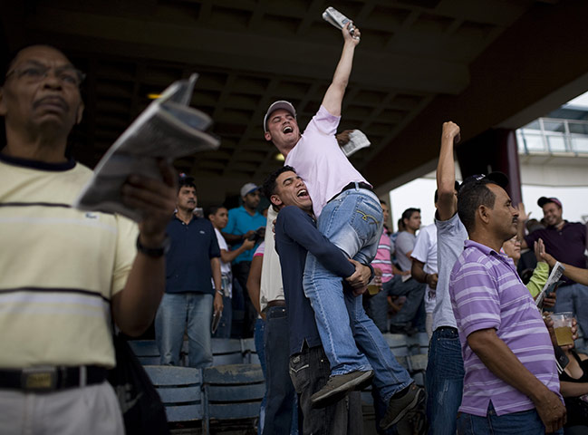 Fromtheagencies Cubillos: Fans celebrate while watching a horse race in Caracas Venezuela