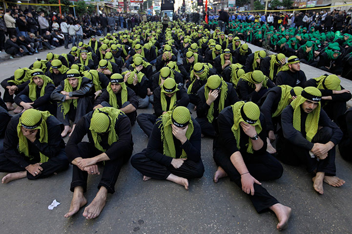 24 hours in pictures: ebanese Shia Muslim men listen during Ashoura day