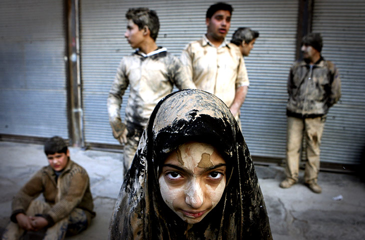 24 hours in pictures: A girl covered with mud during Ashura celebrations