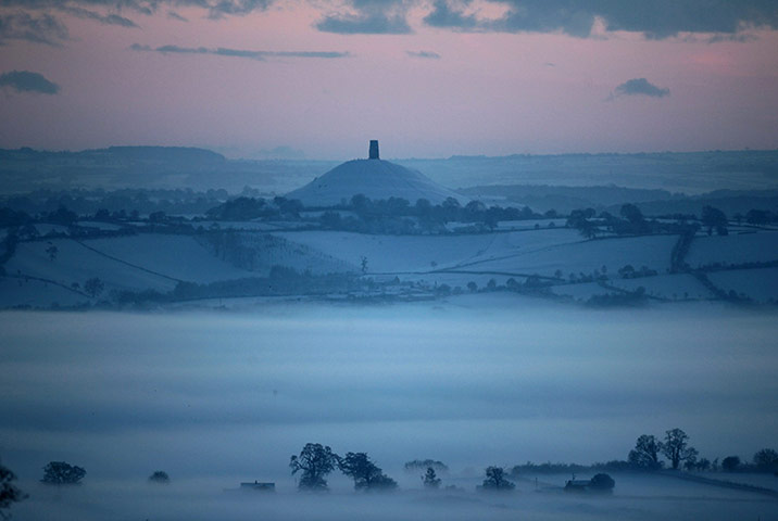 24 hours: Glastonbury, England:  Mist forms across fields as the sun sets