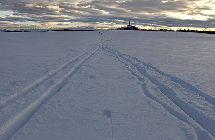 24 hours: Herrsching, Germany: Two skiers make their way through the snow 