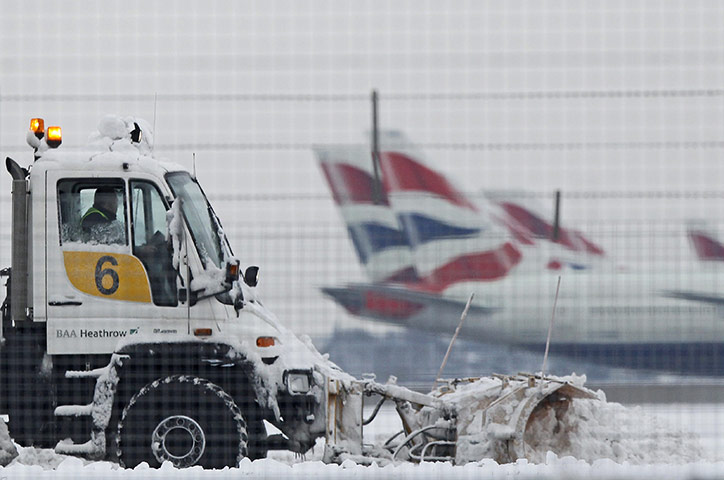 Cold weather continues: A snow plough is driven by a worker at Heathrow Airport in west London