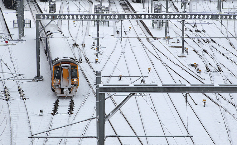Cold weather continues: A train travels over snow-covered tracks as it leaves Waverley Station