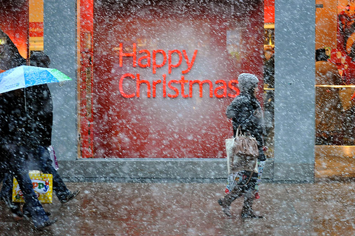Cold weather continues: Christmas shoppers in London's Oxford Street as winter weather returns