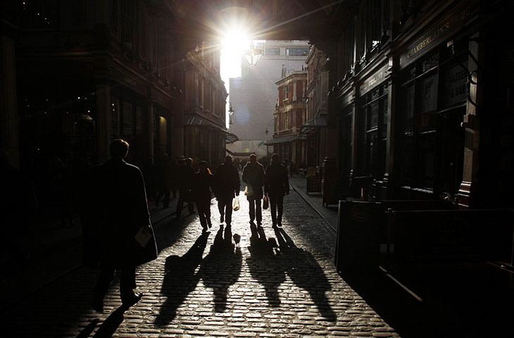 Year in Business: City worker casts shadows in Leadenhall Market in the City of London