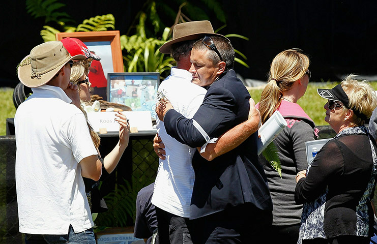 Memorial for NZ Miners: People embrace during a national memorial service for the miners 