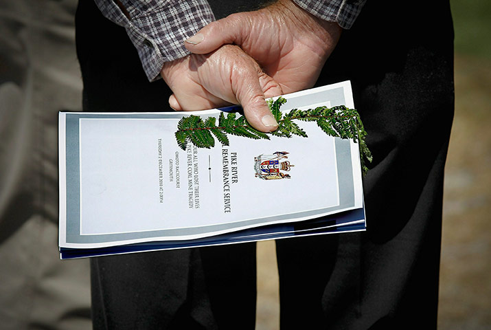 Man with booklet and fern leaf at New Zealand miners memorial service