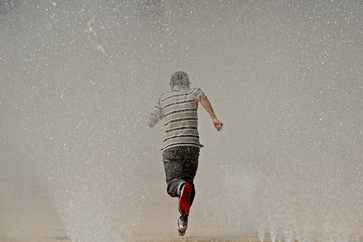 24 hours in pictures: A man runs over the water in a fountain in Mexico City