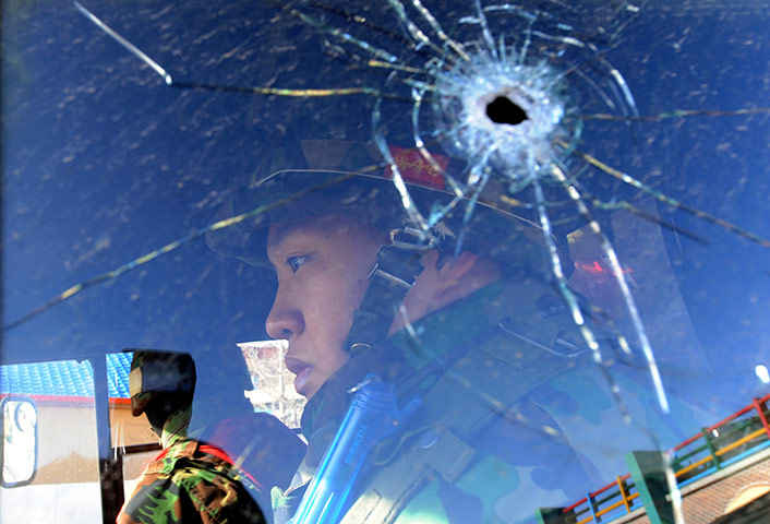 24 hours in pictures: South Korean marines patrol in a vehicle with a window hit by shrapnel