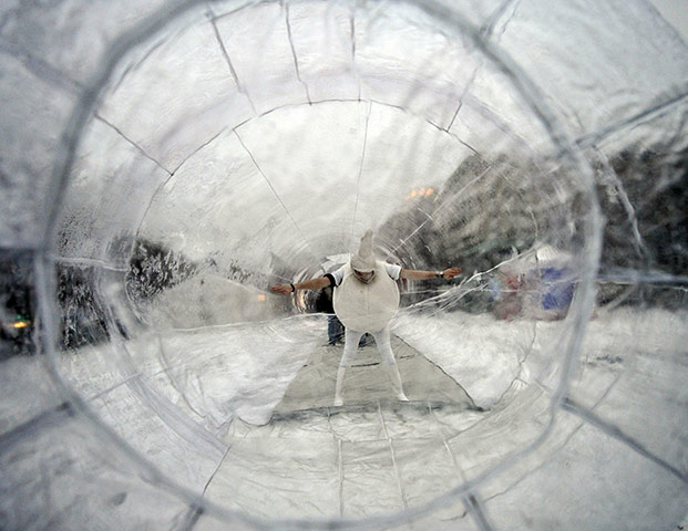24 hours in pictures: A students poses for a photograph while wearing a sperm costume