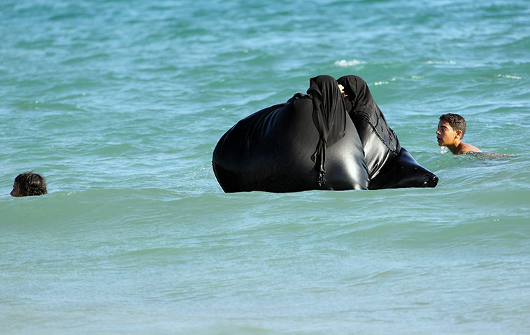 24 hours in pictures: Yemeni women wearing the traditional head-to-toe Islamic covering to swim