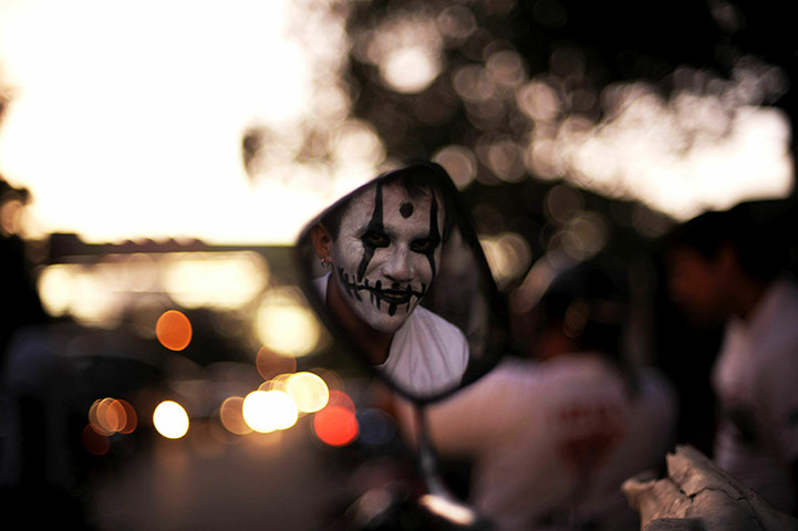 24 hours in pictures: An activist with painted face participates in a march 