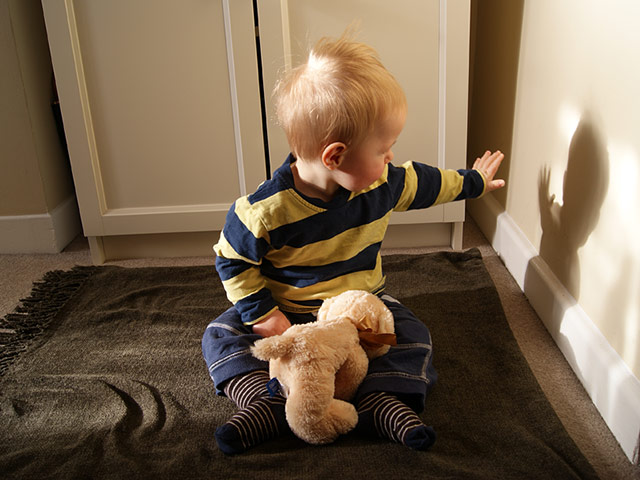 In pictures: touch: boy reaching out to touch his shadow