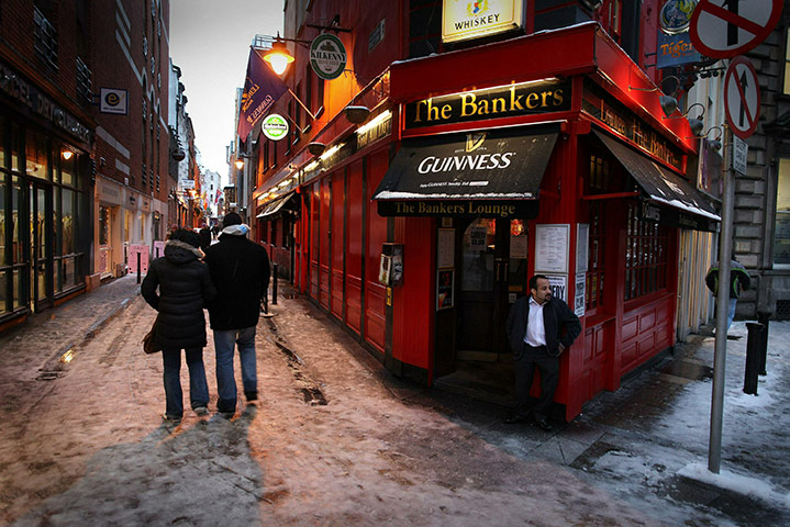 Week in business:  Shoppers pass a pub called The Bankers in Dublin, Ireland
