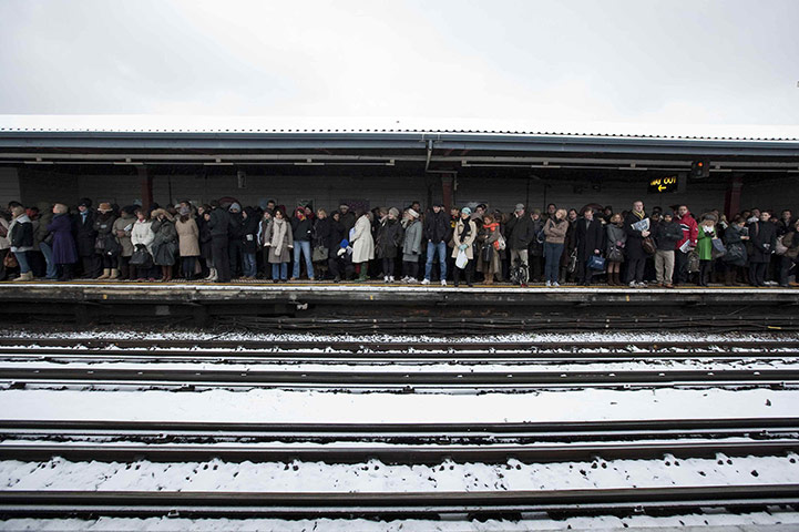 Winter weather: Commuters wait for a tube train at Parsons Green station in London
