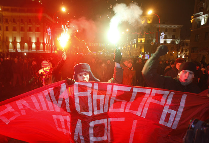 Belarus election violence: Opposition protesters light flares and shout slogans as they rally