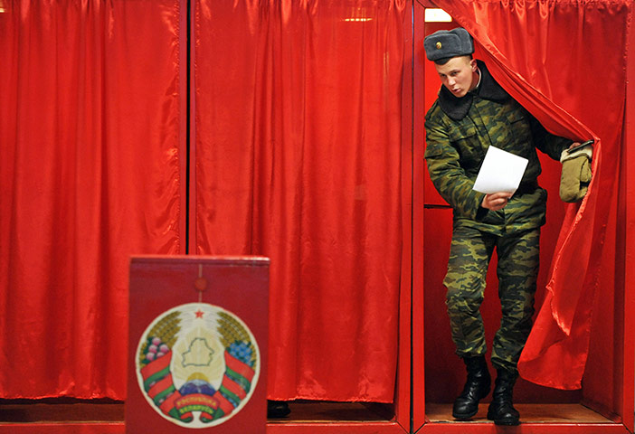 Belarus election violence: A Belarus soldier leaves a polling booth to cast his vote