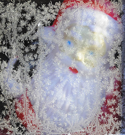 snow continues in uk: A toy Santa Claus