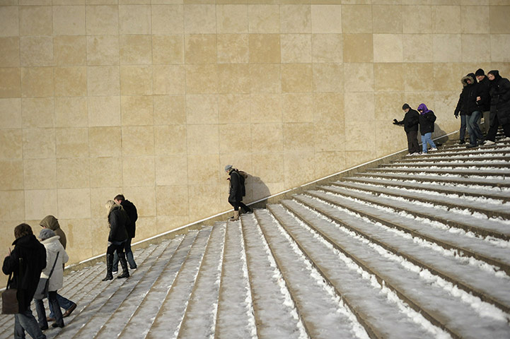 24 hours: People walk carefully downstairs on snow covered stairs in PAris