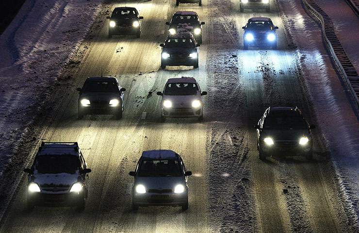 Travel Chaos: Cars drive slowly on a the snowy highway