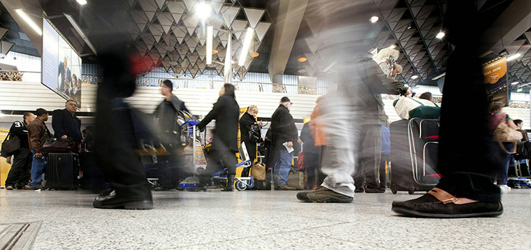 Travel Chaos: Passengers line up to check in at the ai