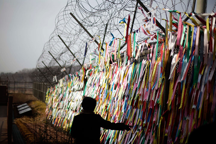 24 hours in pictures: A tourist touches ribbons with messages, South Korea