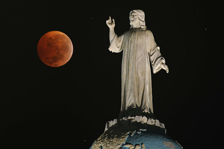 Lunar Eclipse: A double expousure picture shows the moon and The Savior of The World