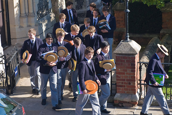 School Uniforms: A group of boys in formal school uniform exit school gates