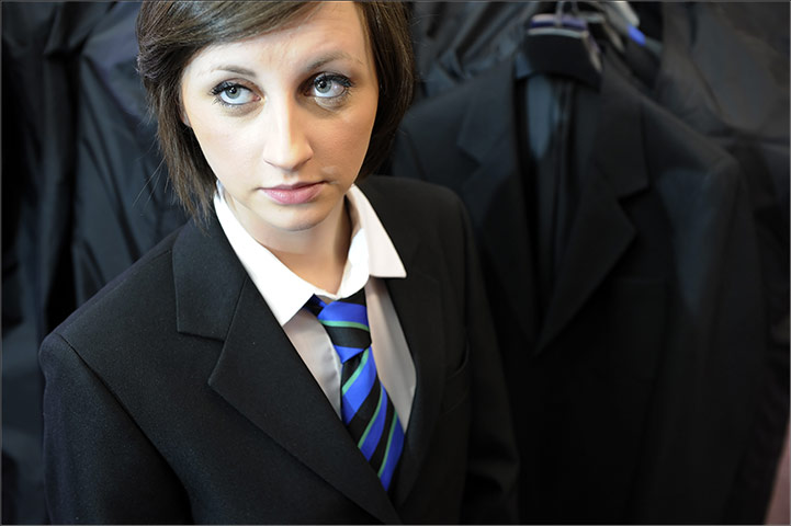 School Uniforms: A girl looks up wearing a smart school tie and blazer