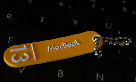 A tag lying across a MacBook keyboard