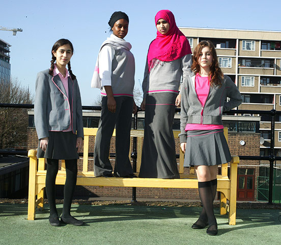 School Uniforms: A group of teenage schoolgirls model a modern grey & pink uniform