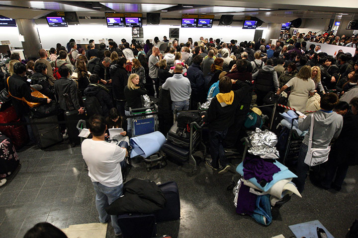 Travel Chaos: Passengers wait in the Departures area of Terminal 3