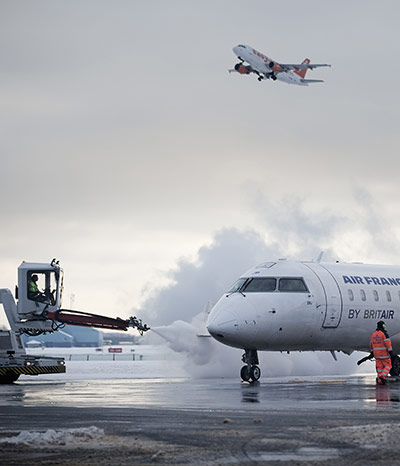 Travel Chaos: An aircraft takes off as another is deiced in Copenhagen