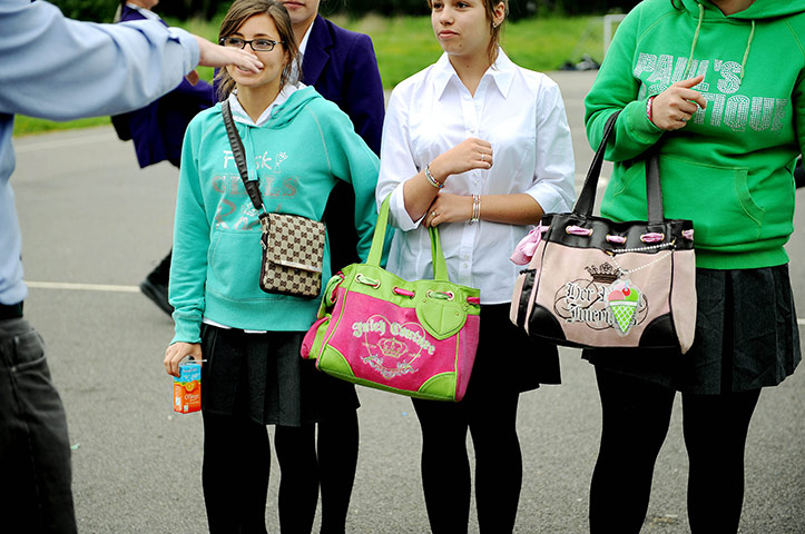 School Uniforms: Three schoolgirls not in uniform carry their fashionable bags
