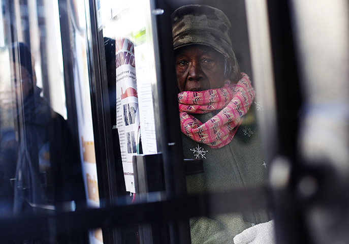 24 hours: New York, USA: A woman waits in line for holiday food distribution