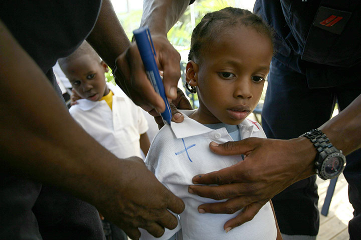 24 hours: Port-au-Prince, Haiti: A volunteer holds a child waiting for adoption
