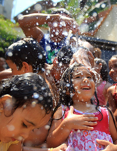 24 hours: Rio de Janeiro, Brazil: Children take a bath at the Complexo do Alemao 